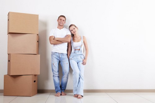 Furniture collection team handling bulky sofa pick-up in a London property