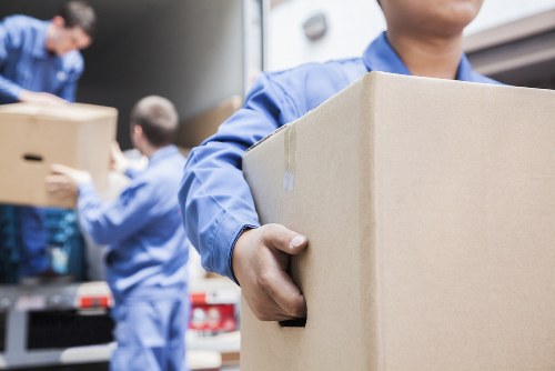 Moving company staff loading boxes with an emphasis on ethical labor practices