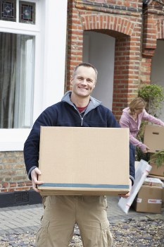 Removal team planning a London home move with boxes and furniture