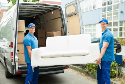 Movers handling belongings safely with protective measures in place