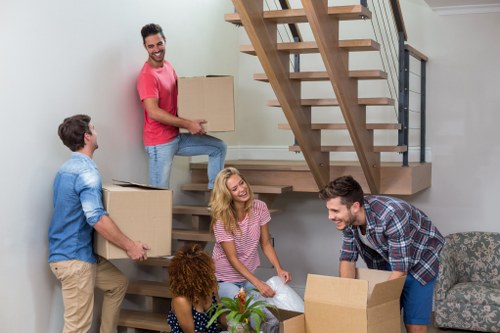 Moving team handling a London home relocation with boxes and furniture