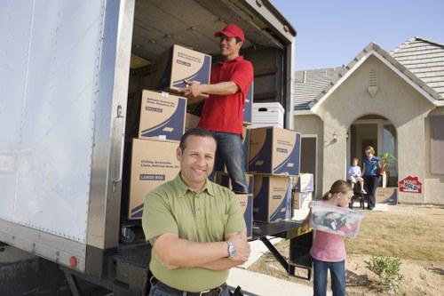 Moving team loading furniture into a removal vehicle