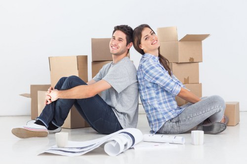 Removal professionals loading furniture from a city flat in London