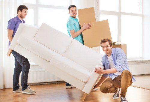 Removal crew handling a sofa during delivery