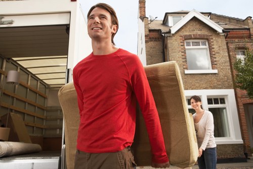 Moving crew loading furniture into a truck for a flat relocation in London
