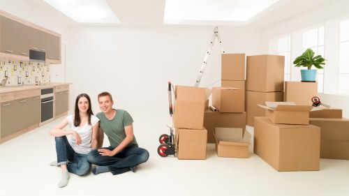 Movers loading household furniture in a London residential street