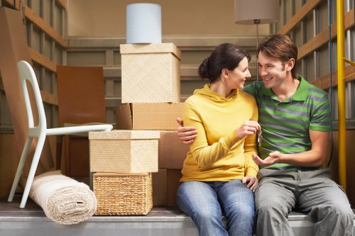 Removal van loading furniture outside a London apartment building